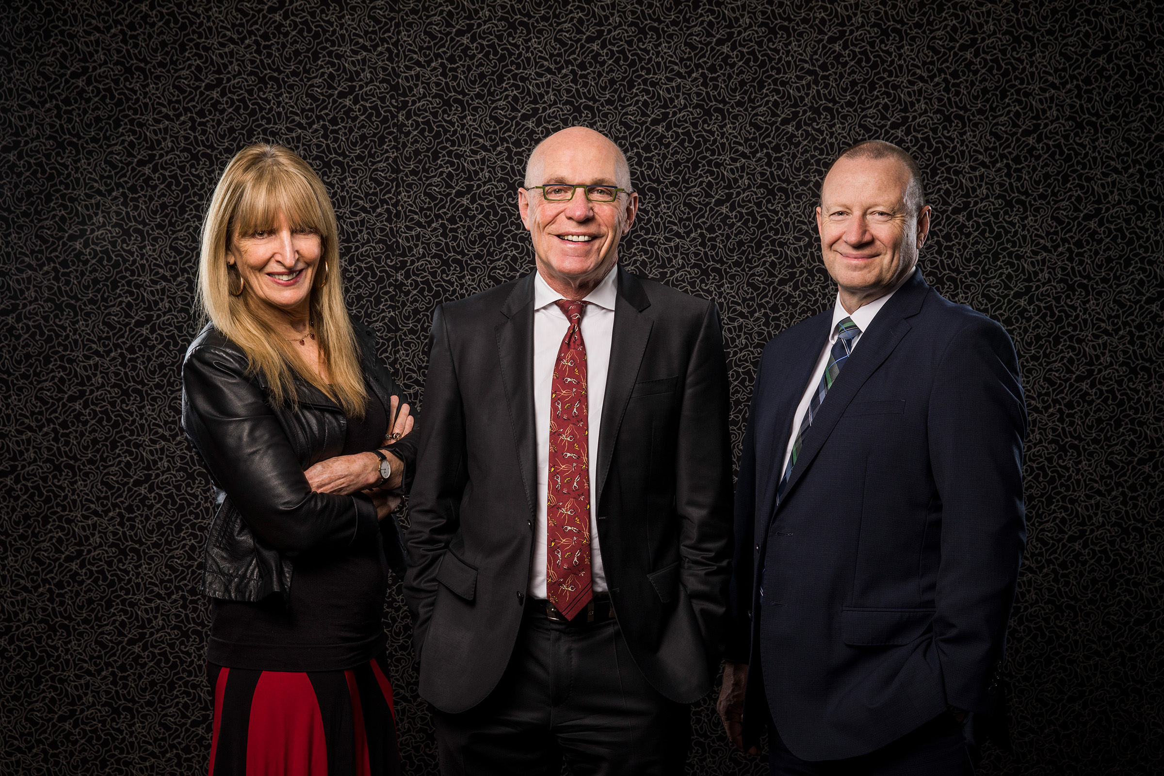 Corporate group photography Sonic Healthcare Colin Goldschmidt one woman 2 men black white textured background